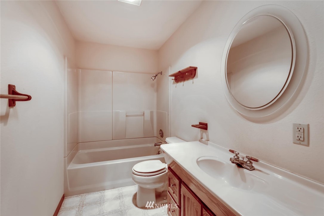 1908 233rd Place Southeast Bothell, WA 98021 - Photo 20 of 24 a bathroom with a sink a toilet and a mirror