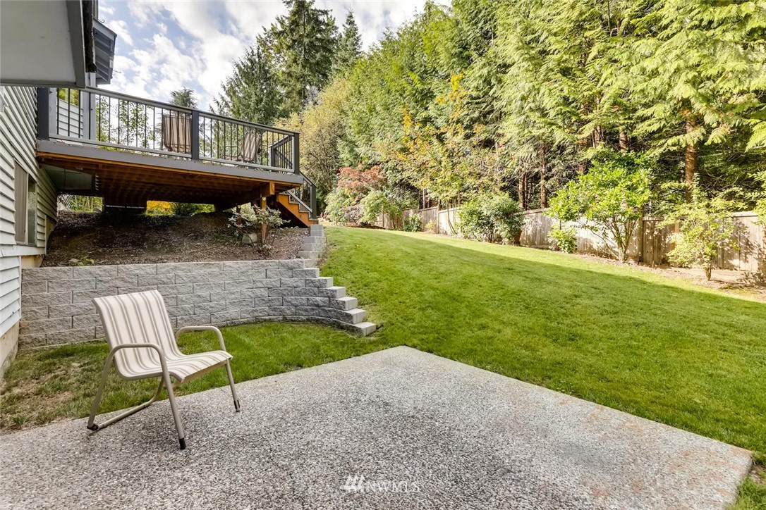 1908 233rd Place Southeast Bothell, WA 98021 - Photo 23 of 24 a view of backyard with a table and chairs