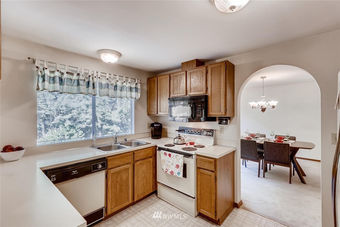 1908 233rd Place Southeast Bothell, WA 98021 - Photo 6 of 24 a kitchen that has a sink a stove and chairs