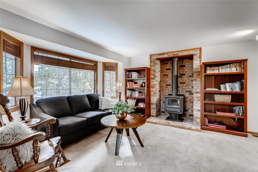 1908 233rd Place Southeast Bothell, WA 98021 - Photo 9 of 24 a living room with furniture and a large window with a book shelf