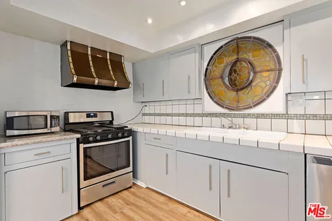 a kitchen with a stove and a sink