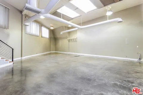 an empty room with windows and entrance