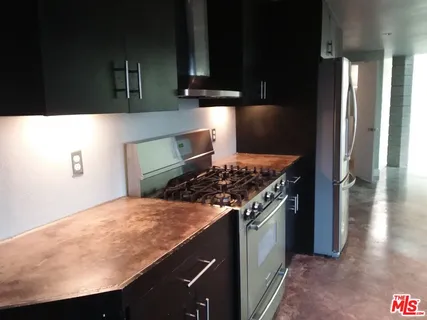 a kitchen with a stove and a refrigerator