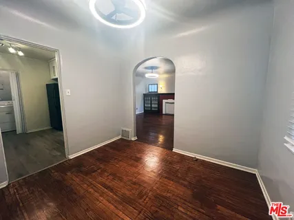 wooden floor in an empty room with a mirror