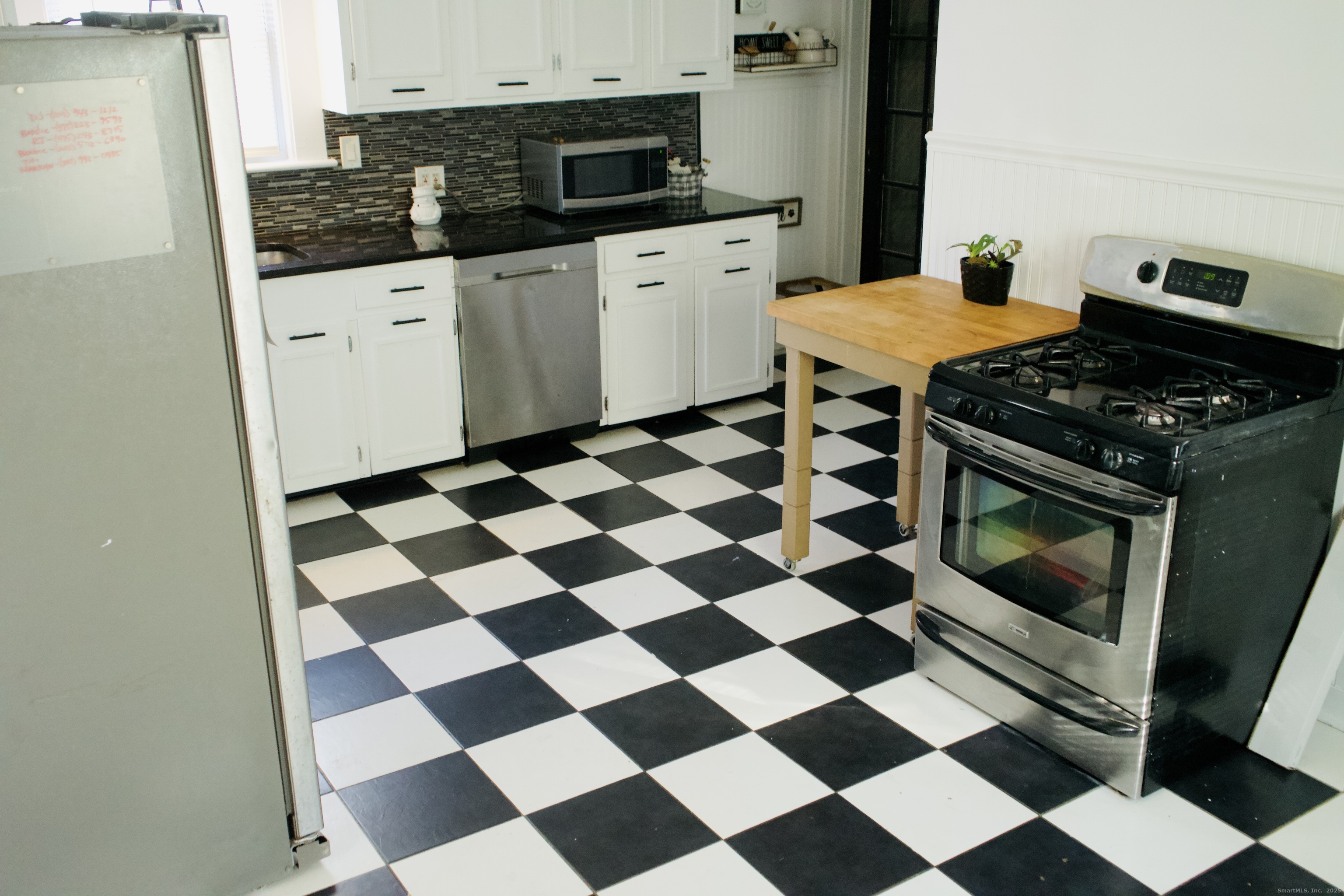 66 North Hoadley Street Naugatuck, CT 06770 - Photo 17 of 22 a kitchen with a checkered floor and steel appliances