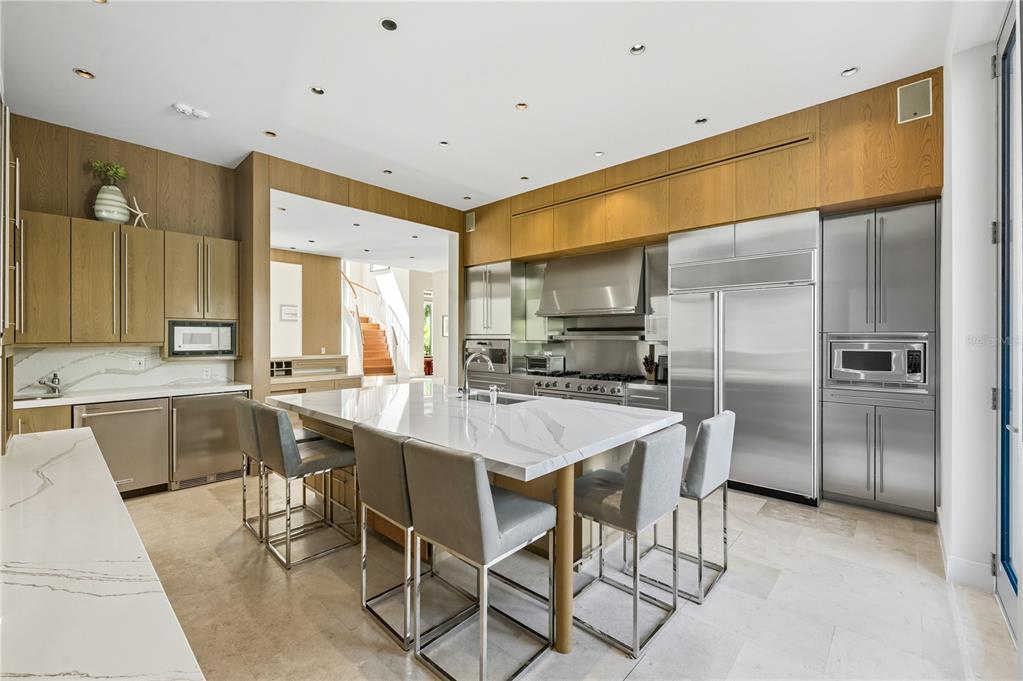 3315 Bay Shore Road Sarasota, FL 34234 - Photo 29 of 96 a kitchen with a table chairs refrigerator and cabinets