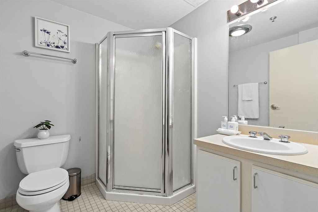 534 Commonwealth Avenue, Unit 3A Boston, MA 02215 - Photo 10 of 18 a bathroom with a toilet a sink and a mirror