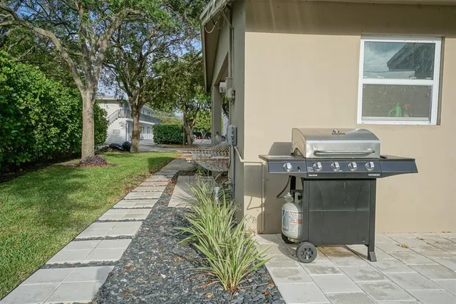 a view of a patio with table and chairs and potted plants