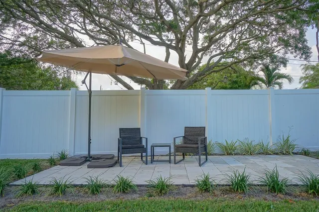 a couple of chairs sitting in backyard of house