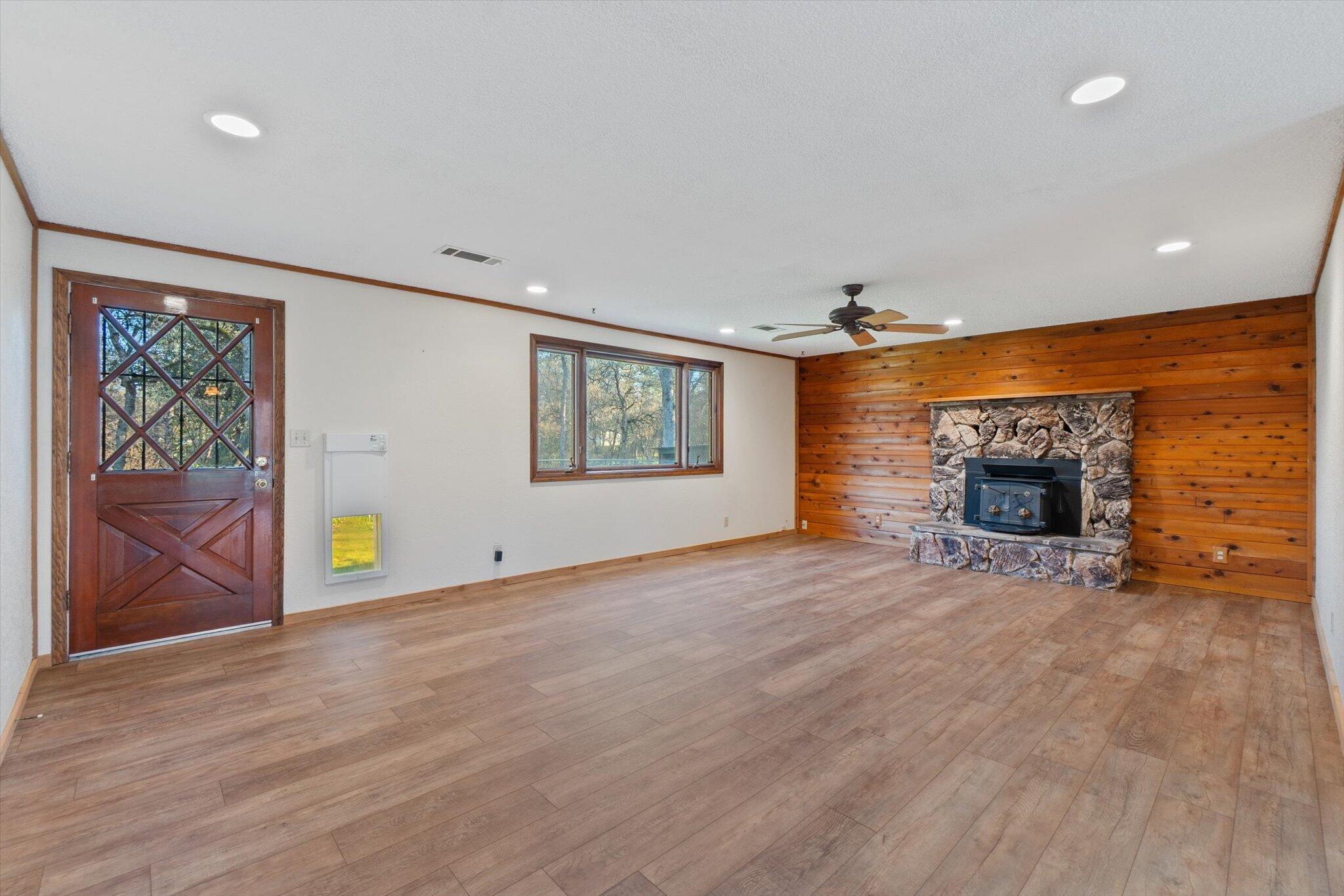 8003 Narrows Way Redding, CA 96001 - Photo 12 of 40 an empty room with windows and fireplace