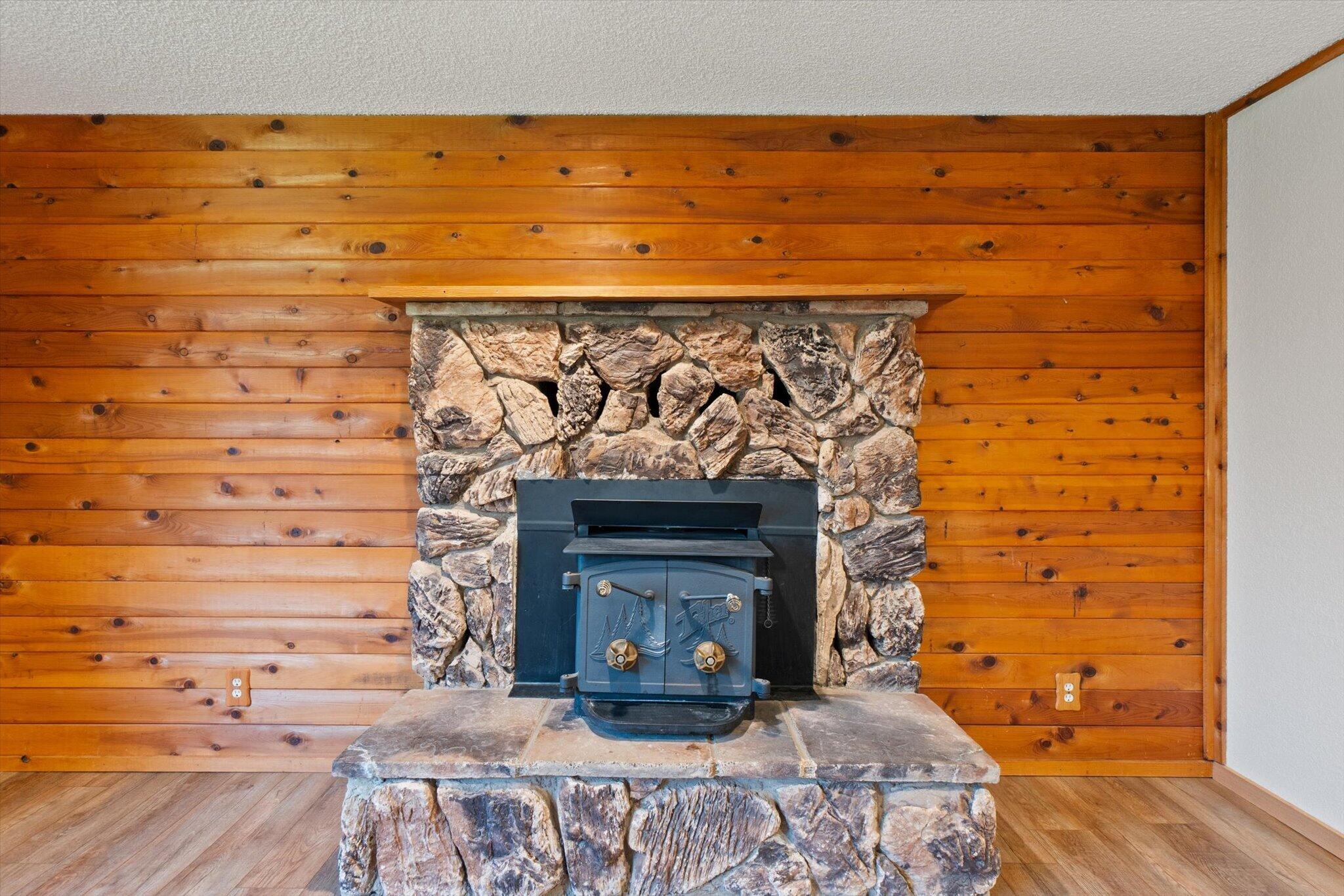 8003 Narrows Way Redding, CA 96001 - Photo 15 of 40 a fireplace with a wooden floor