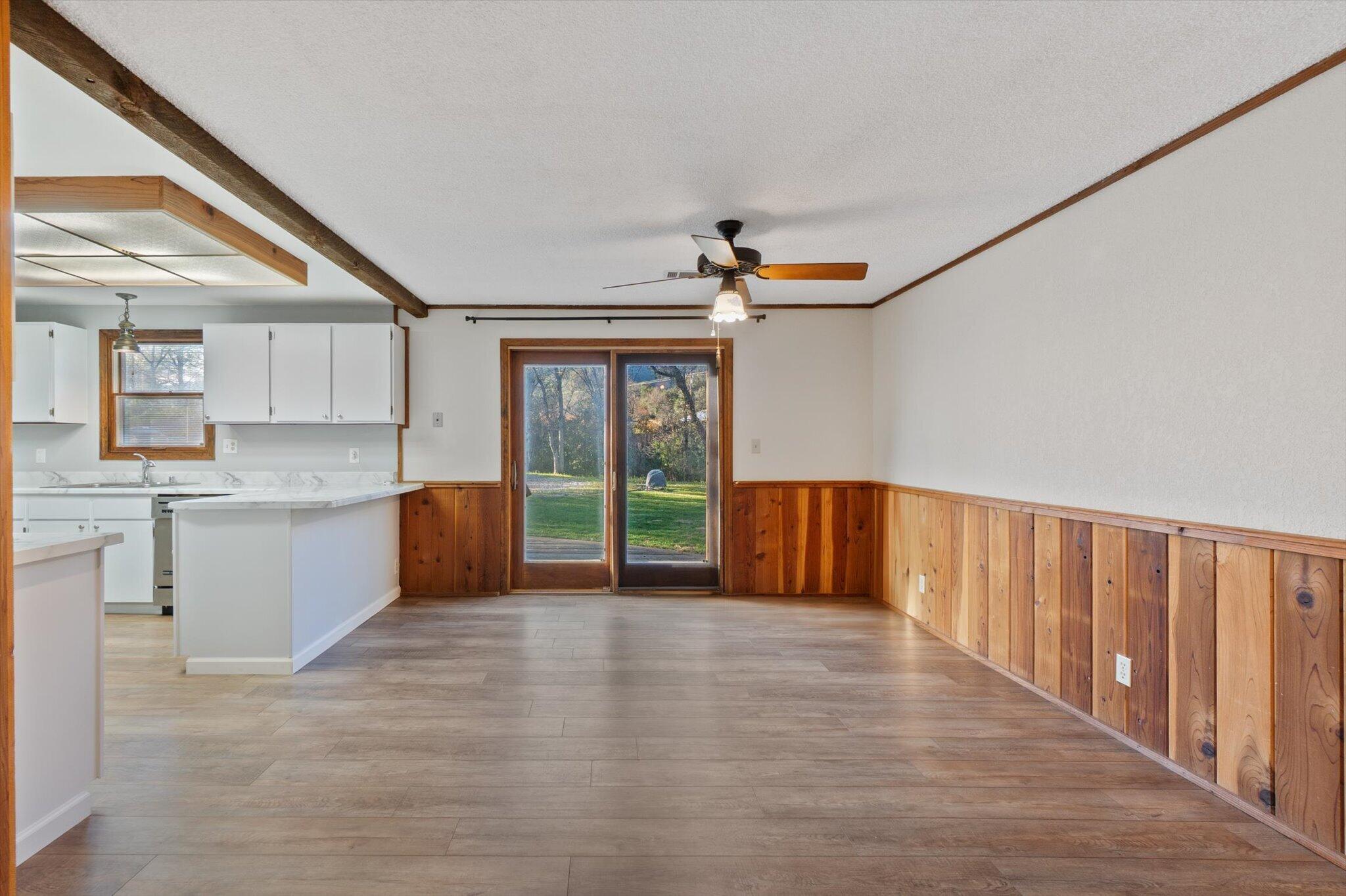 8003 Narrows Way Redding, CA 96001 - Photo 16 of 40 a view of an empty room with window and wooden floor