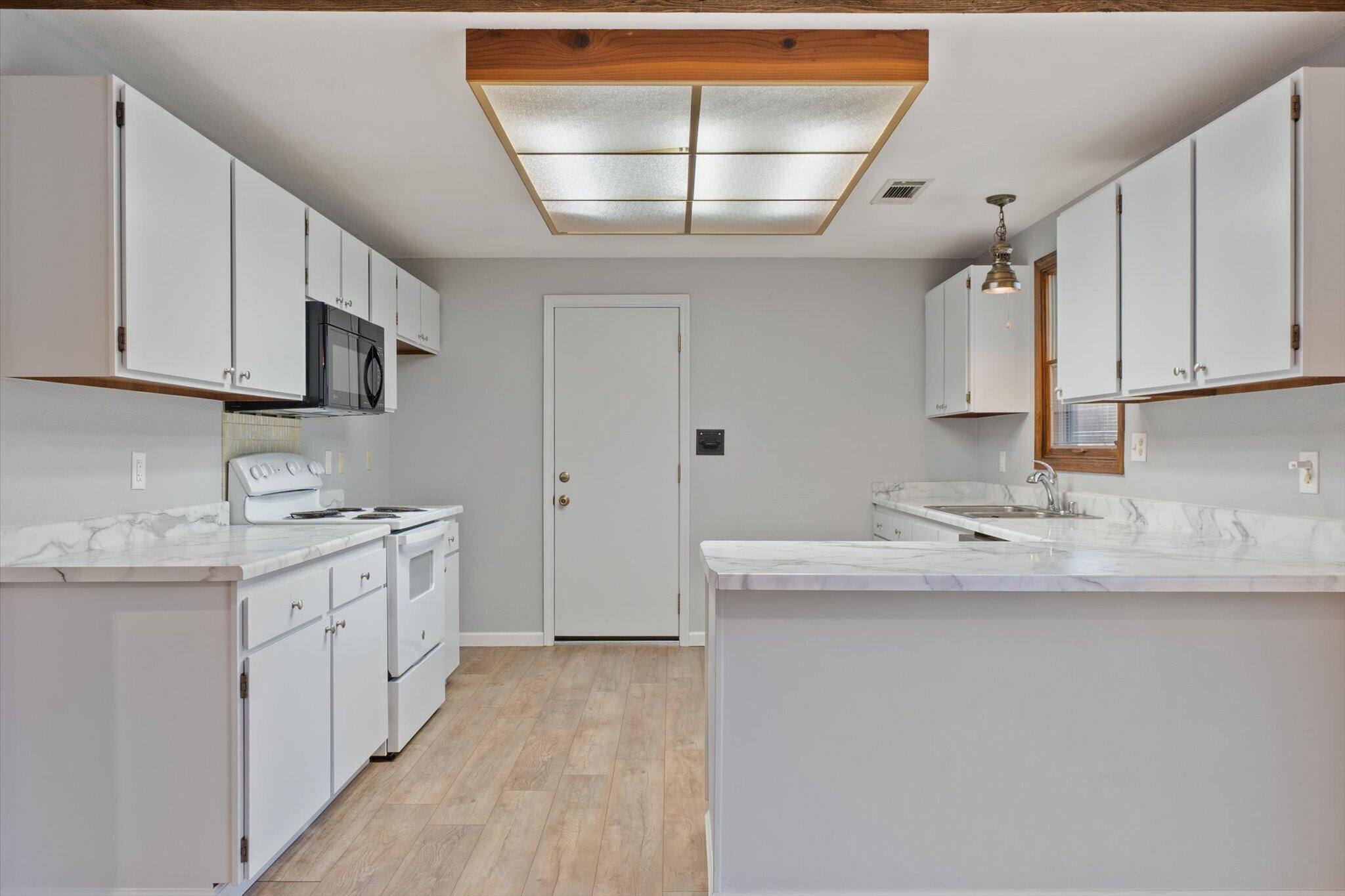 8003 Narrows Way Redding, CA 96001 - Photo 18 of 40 a kitchen with a sink stove and cabinets