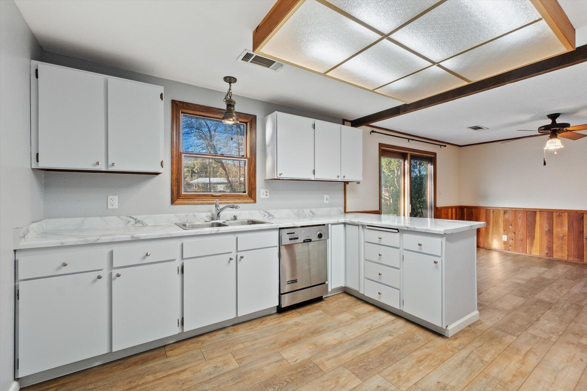 8003 Narrows Way Redding, CA 96001 - Photo 20 of 40 a kitchen with granite countertop white cabinets and white appliances