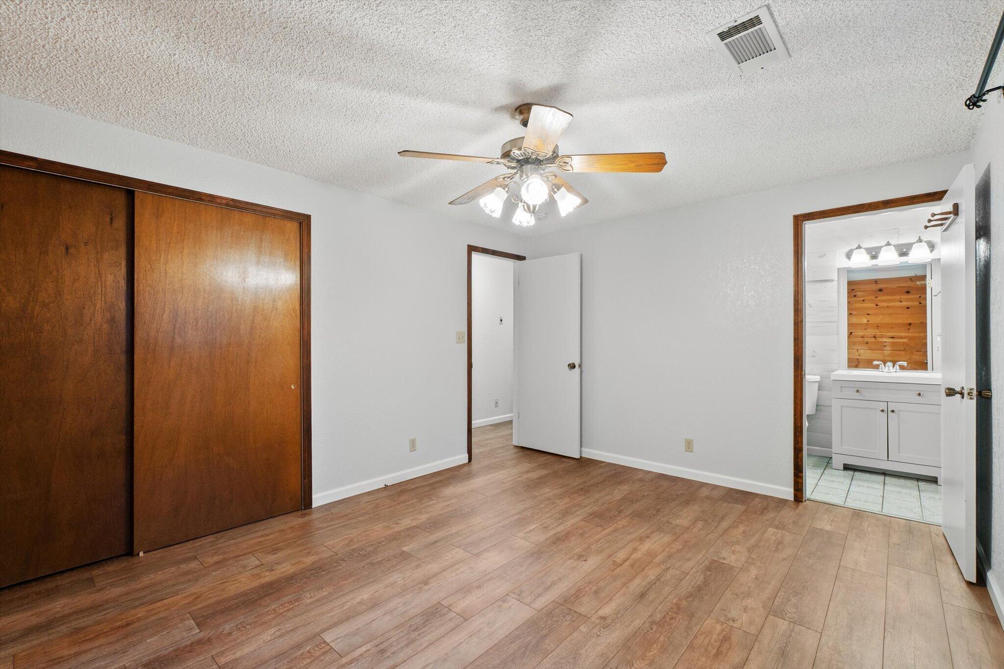 8003 Narrows Way Redding, CA 96001 - Photo 22 of 40 a view of an empty room with window and wooden floor