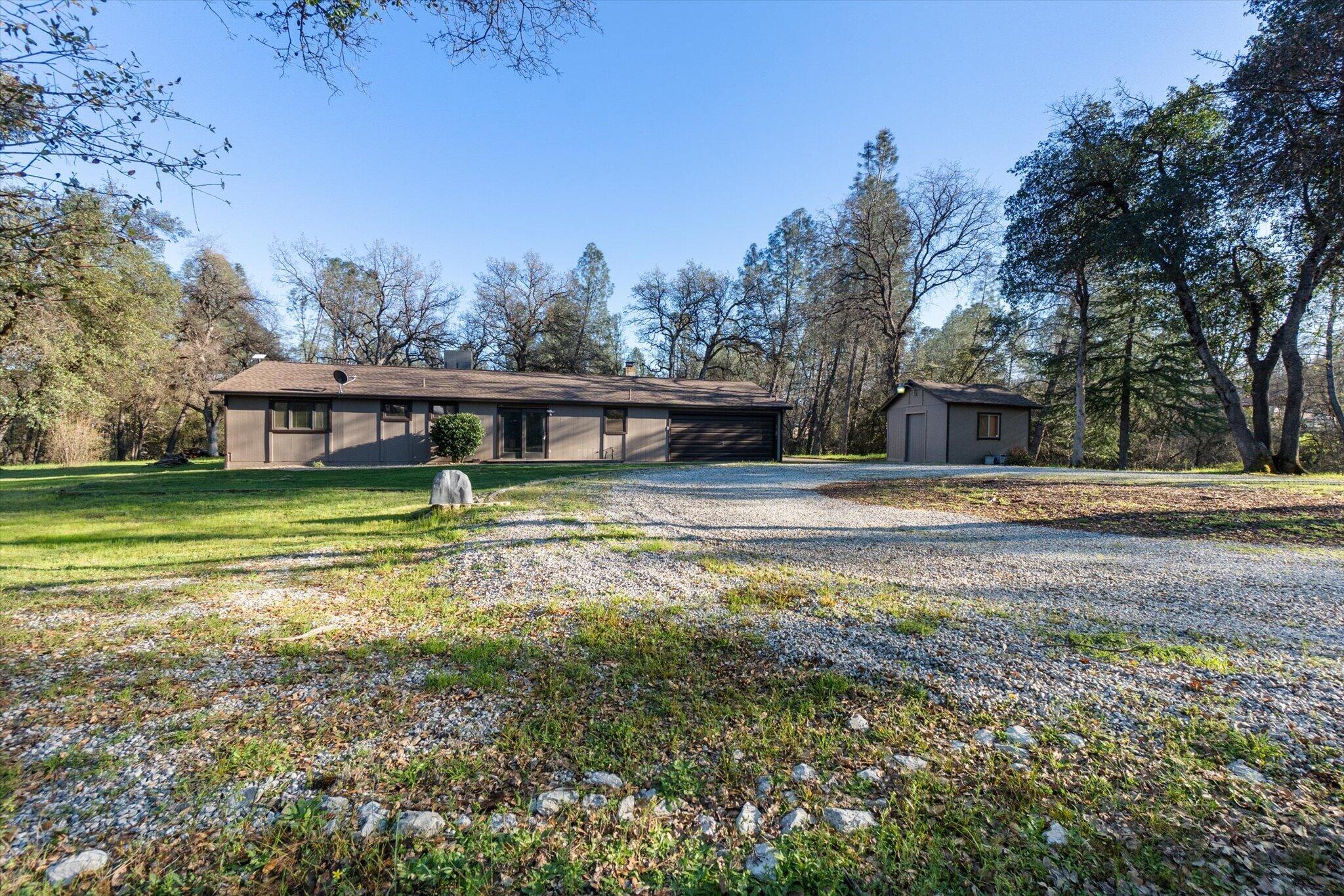 8003 Narrows Way Redding, CA 96001 - Photo 8 of 40 a view of house with garden space and trees in the background