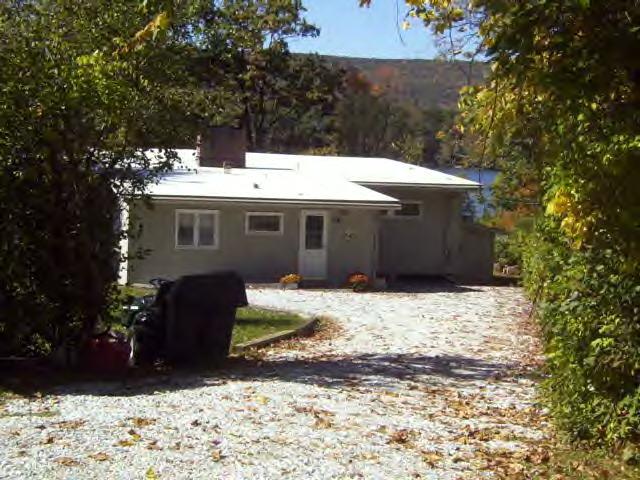 9 Mahkeenac Road Stockbridge, MA 01262 - Photo 3 of 8 a view of a house with a snow in the yard