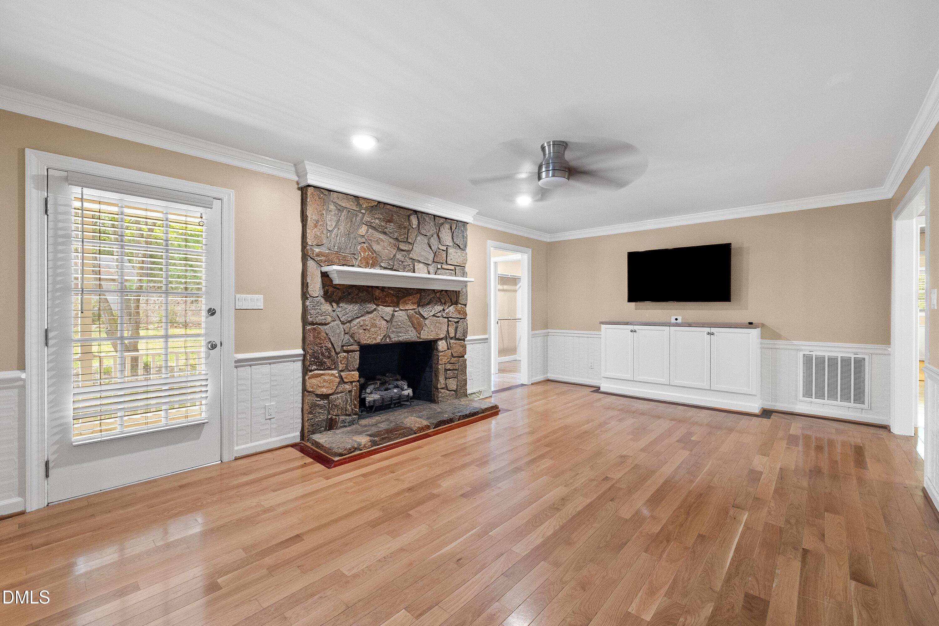 8133 Holly Forest Road Wake Forest, NC 27587 - Photo 6 of 50 a view of a livingroom with a fireplace and a window