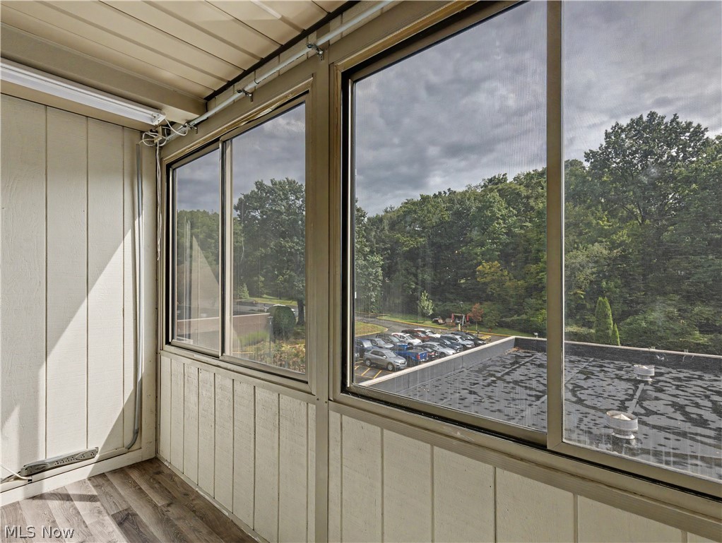 3064 Kent Road Stow, OH 44224 - Photo 15 of 30 Enclosed patio featuring sliding windows, wood-finish flooring, and vertical paneling