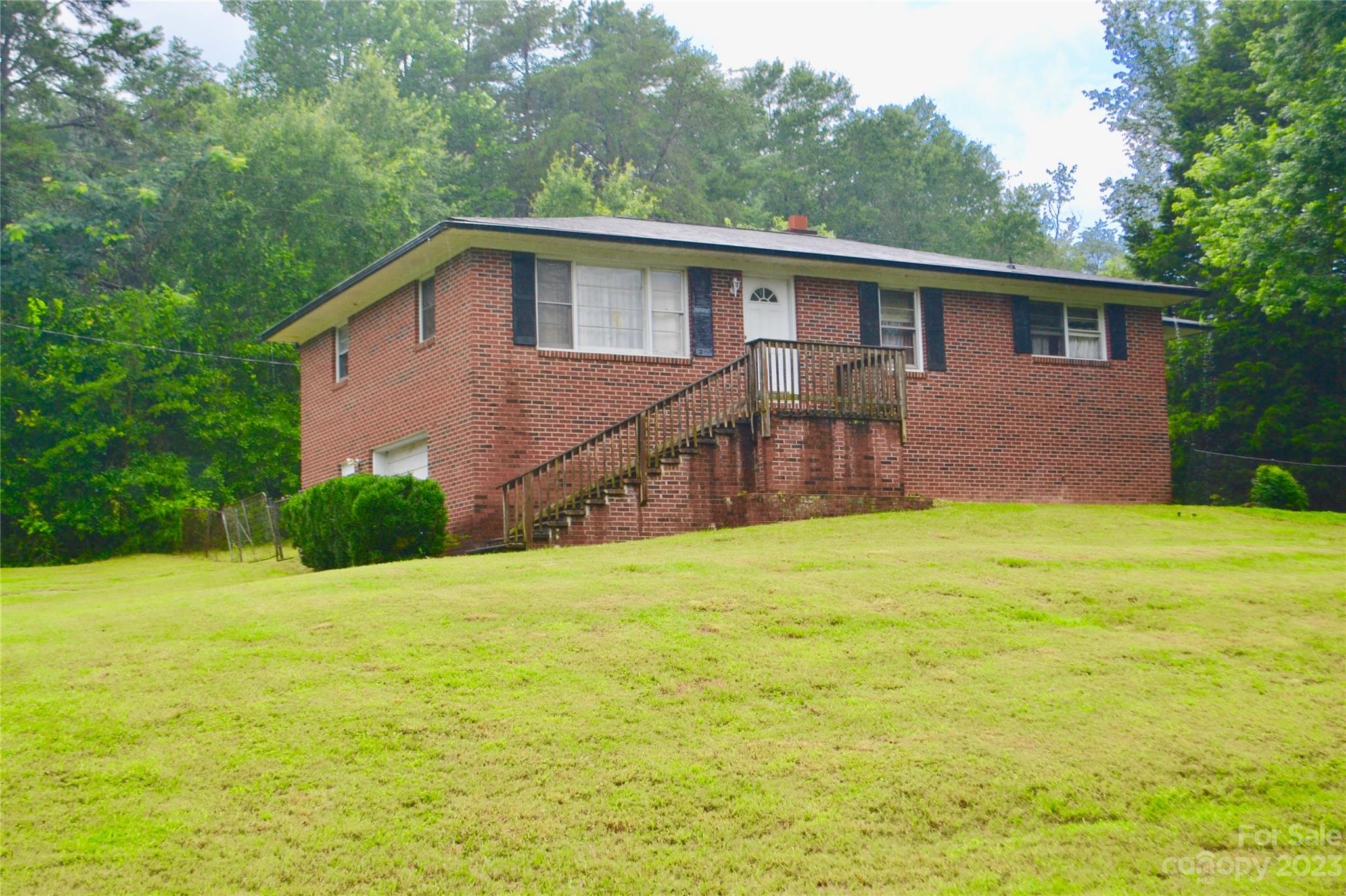 253 Green Acres Road Mooresboro, NC 28114 - Photo 2 of 20 a view of a house with a backyard