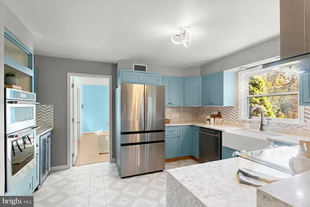 a kitchen with a refrigerator sink and stove