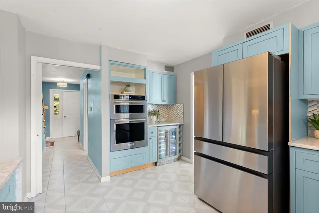 a kitchen with stainless steel appliances a refrigerator and cabinets