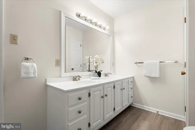 a bathroom with a double vanity sink and mirror