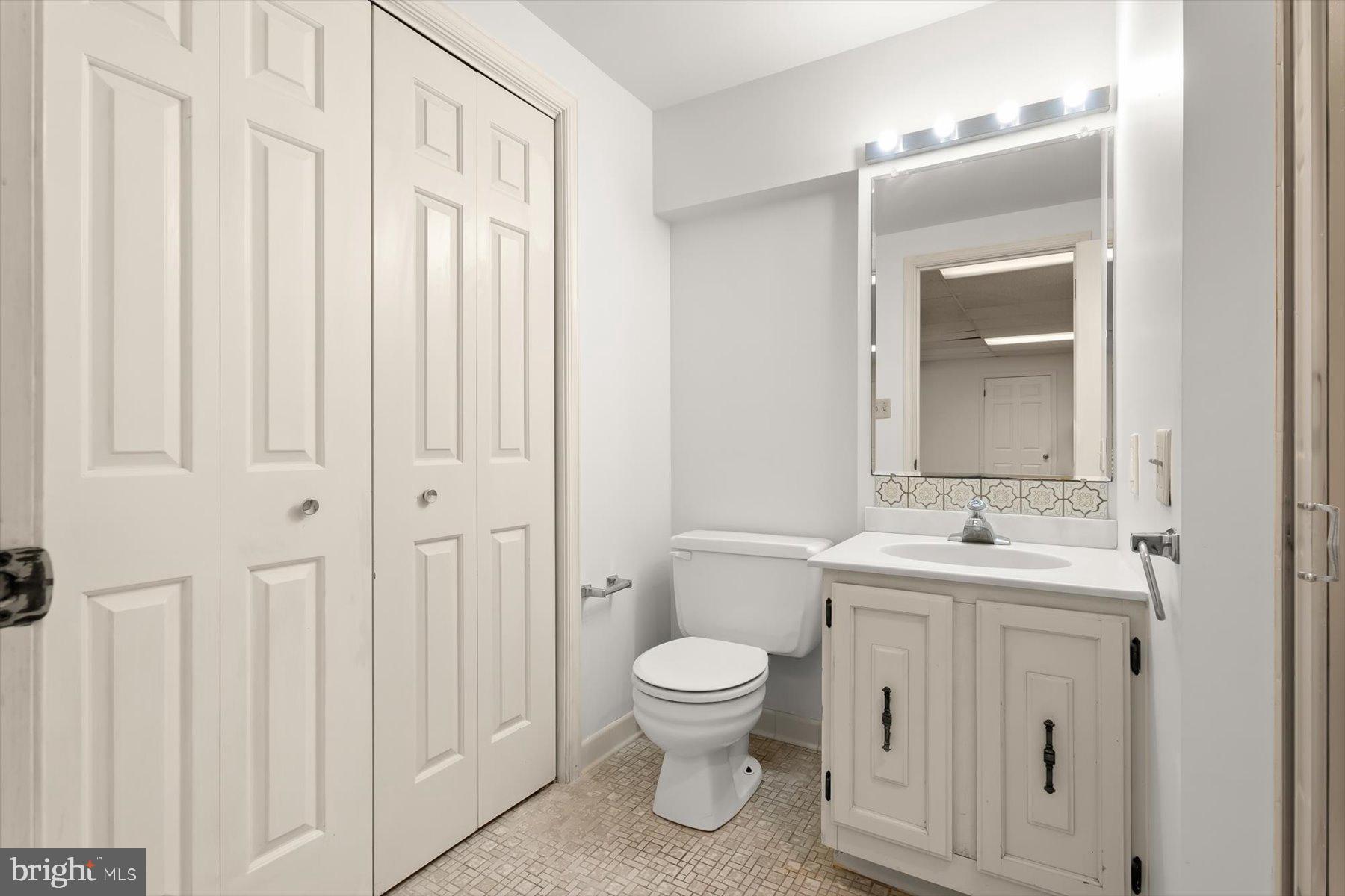 9600 Watkins Road Gaithersburg, MD 20882 - Photo 37 of 47 a bathroom with a toilet a sink and a mirror