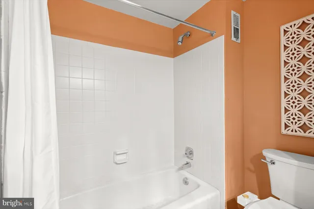 a bathroom with a bathtub and shower