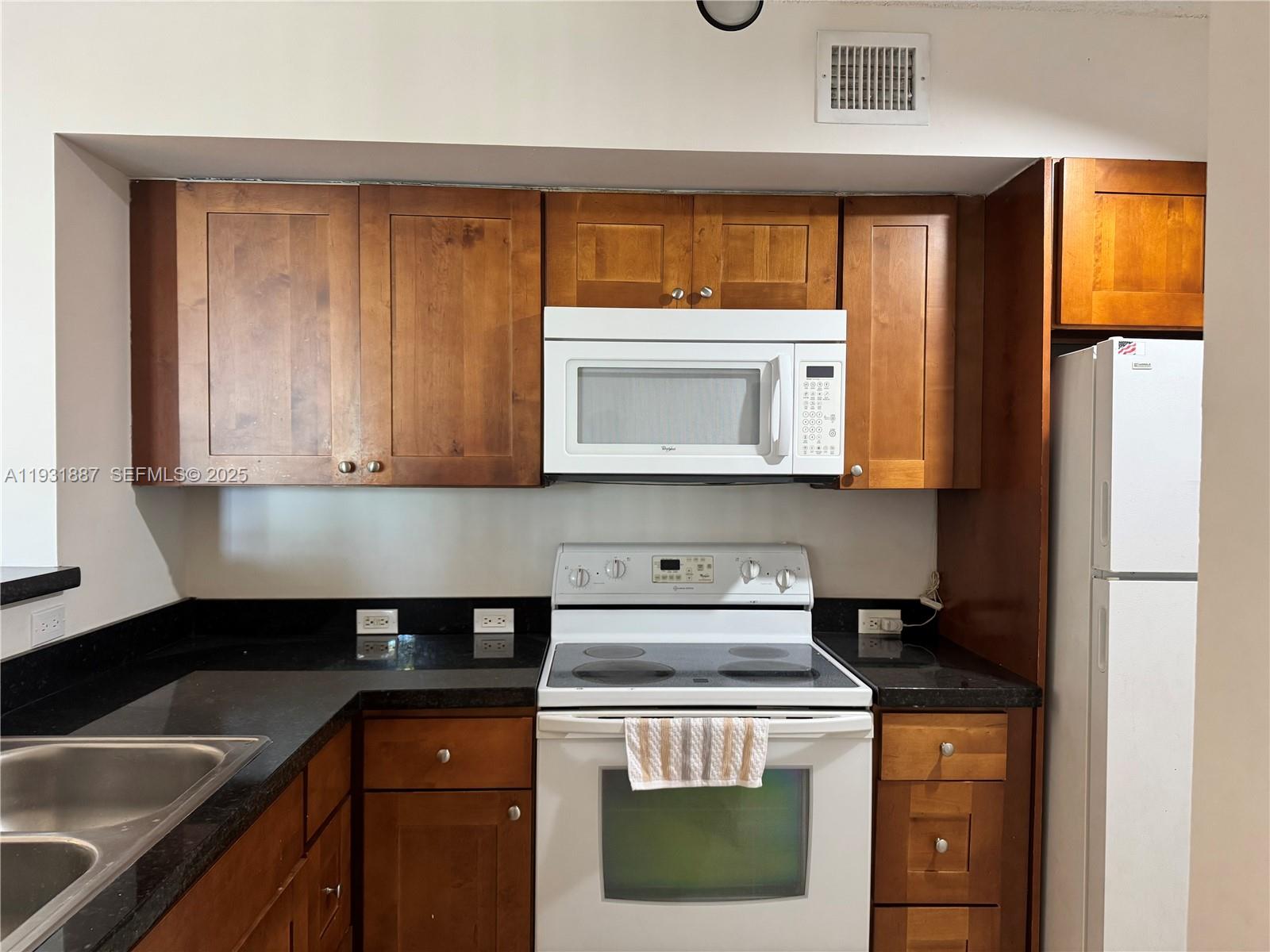 a kitchen with a stove a sink and a microwave