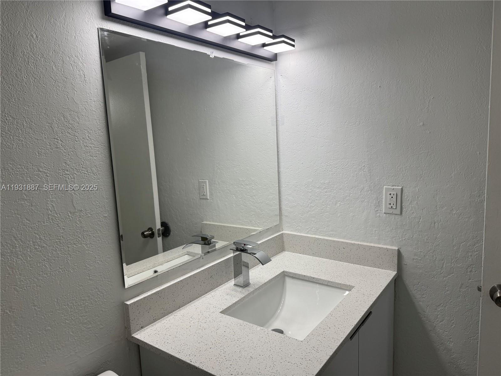 11145 Southwest 6th Street, Unit 104 Pembroke Pines, FL 33025 - Photo 15 of 37 a bathroom with a sink and mirror