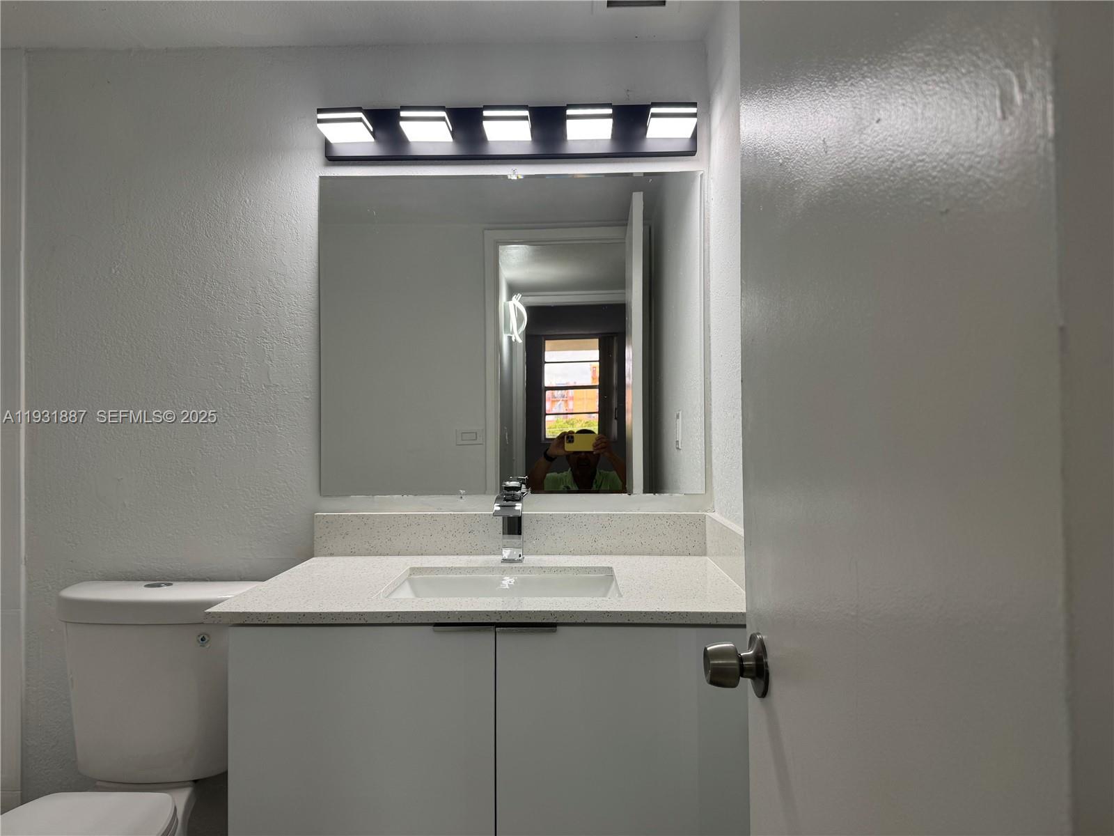 11145 Southwest 6th Street, Unit 104 Pembroke Pines, FL 33025 - Photo 16 of 37 a bathroom with a sink and a mirror