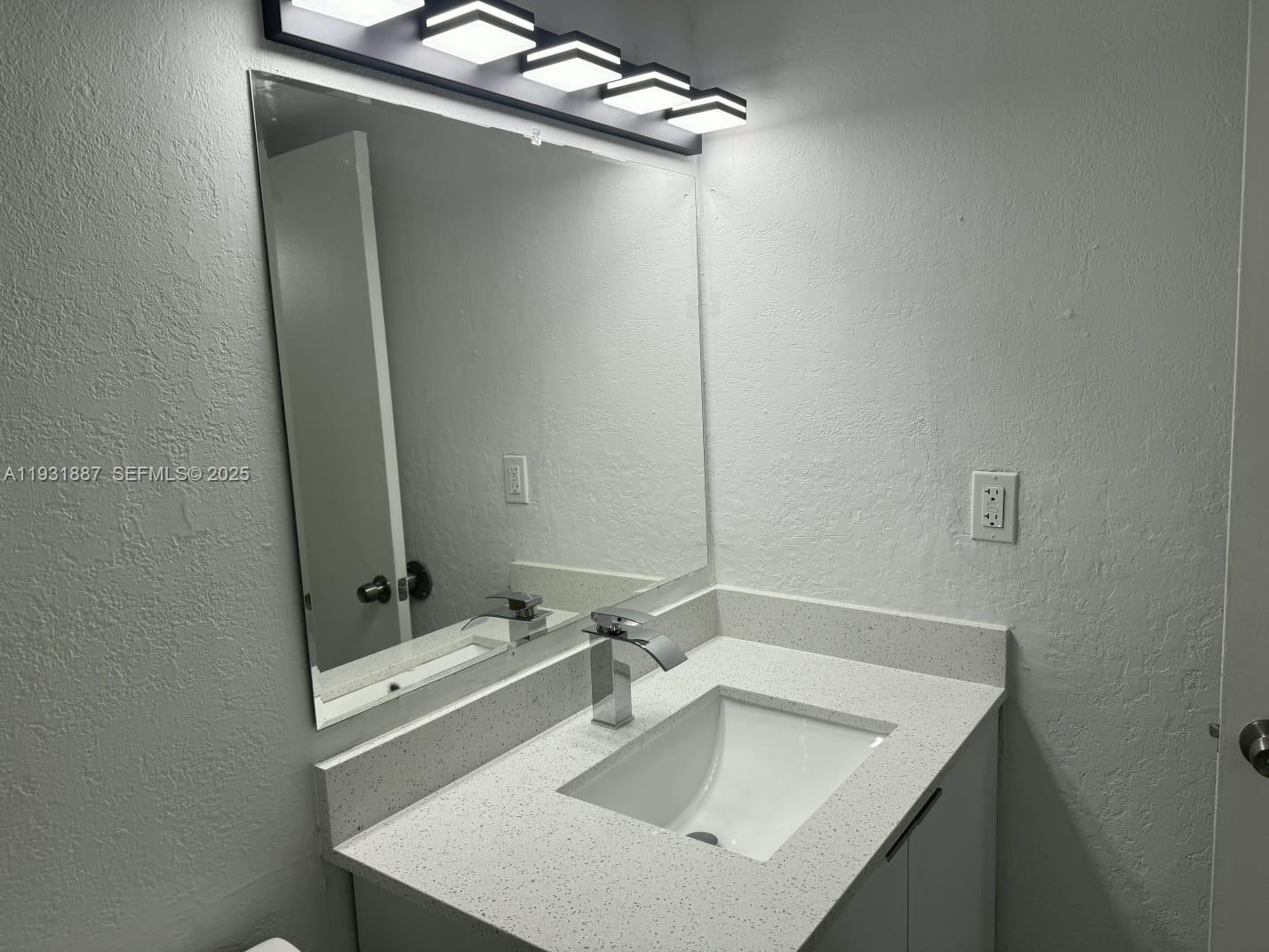 11145 Southwest 6th Street, Unit 104 Pembroke Pines, FL 33025 - Photo 17 of 37 a bathroom with a sink and mirror