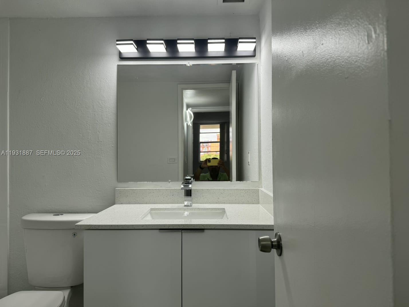 11145 Southwest 6th Street, Unit 104 Pembroke Pines, FL 33025 - Photo 18 of 37 a bathroom with a sink and a mirror