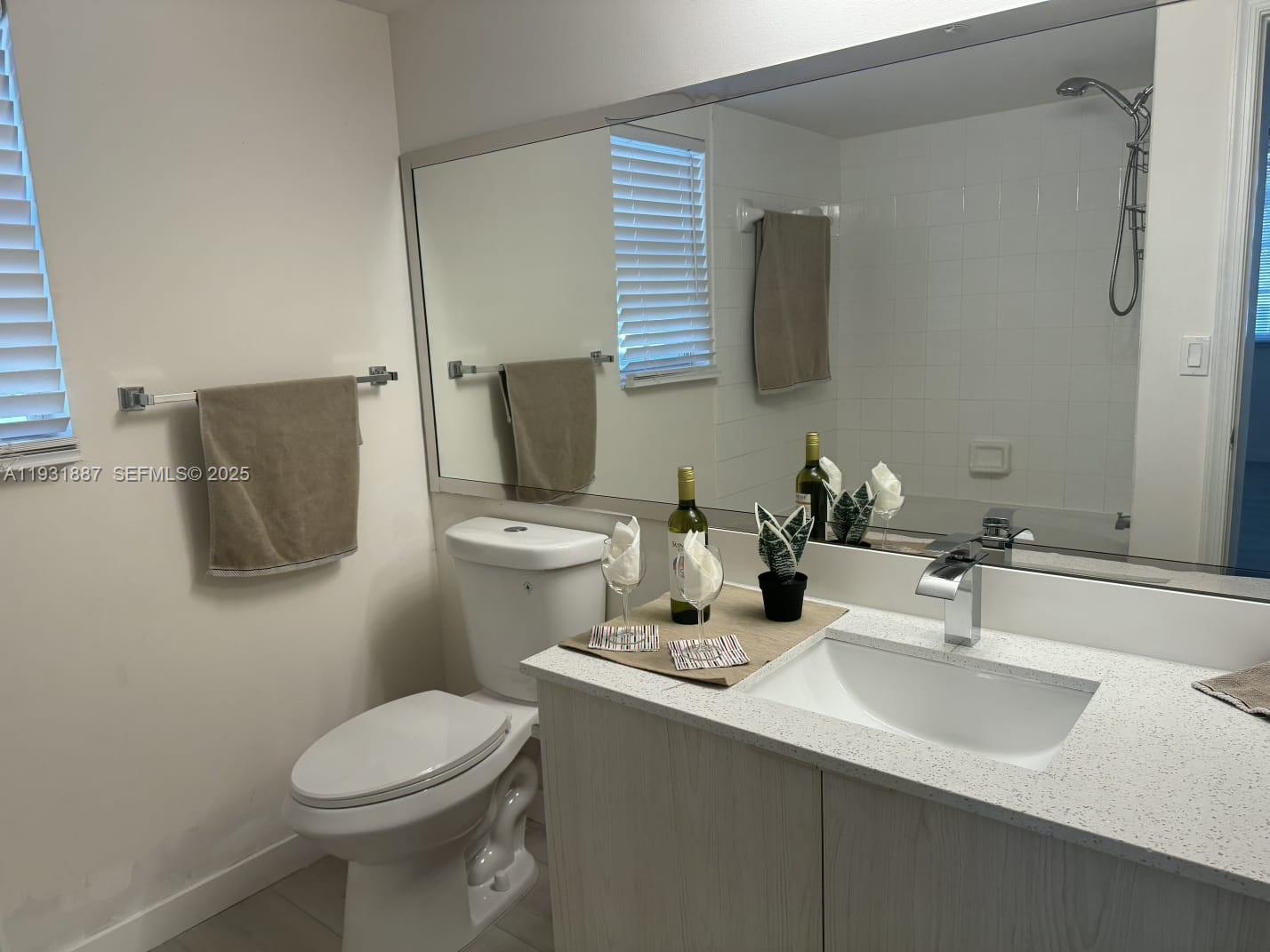 11145 Southwest 6th Street, Unit 104 Pembroke Pines, FL 33025 - Photo 20 of 37 a bathroom with a sink toilet and mirror
