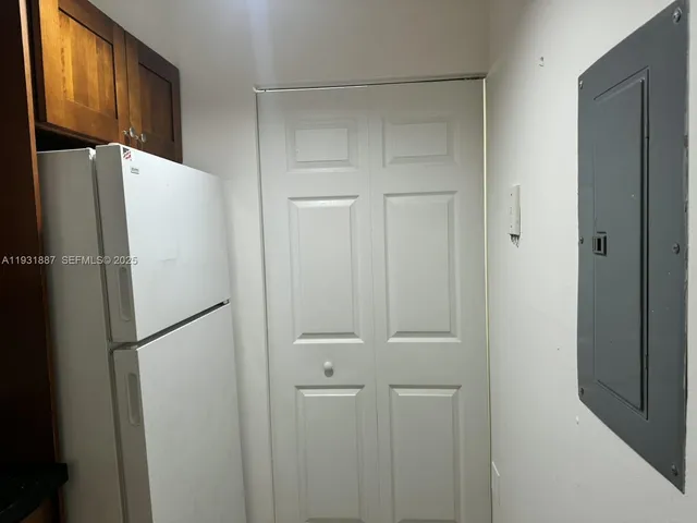 a white refrigerator freezer and a refrigerator in a kitchen