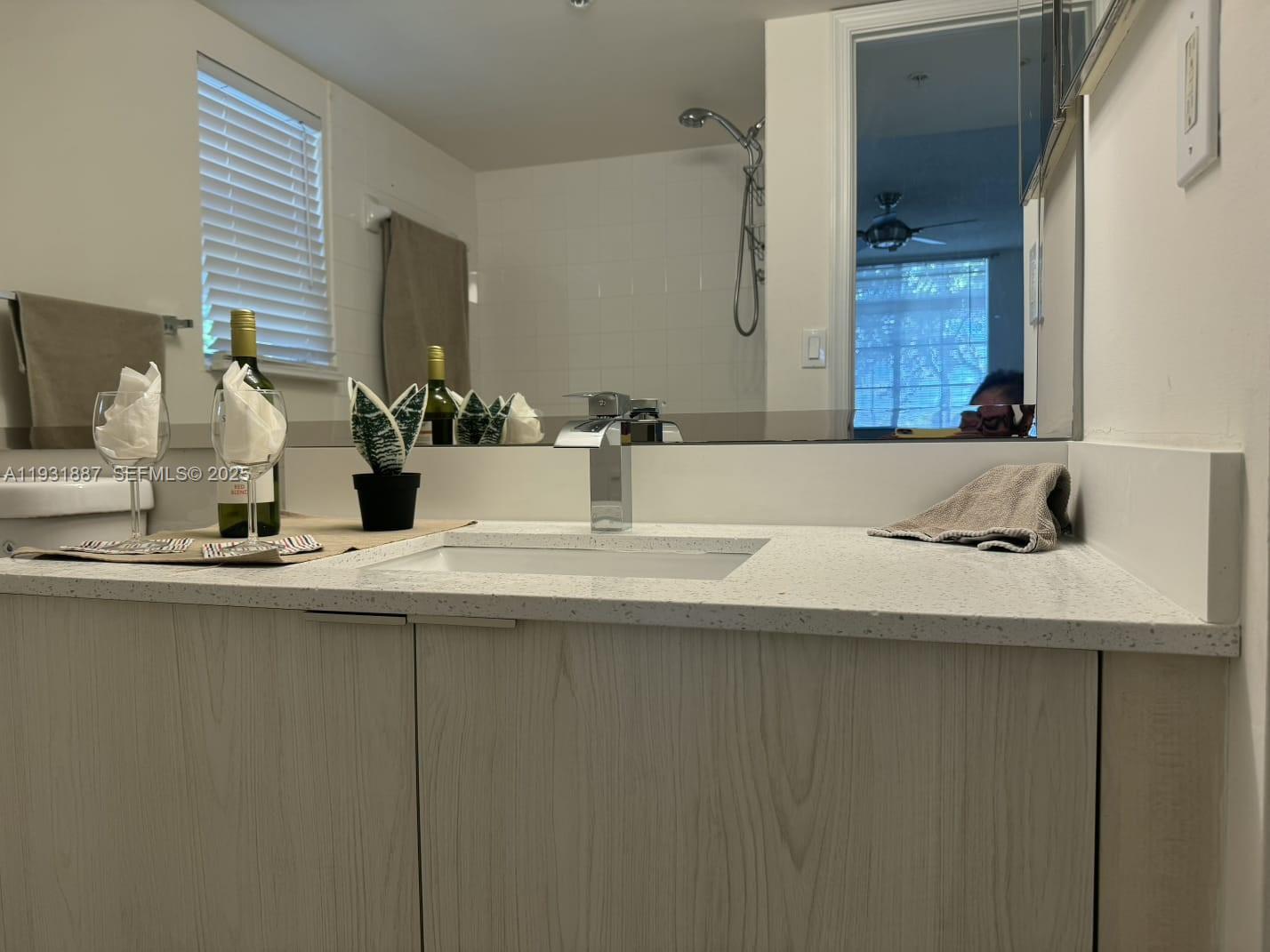 11145 Southwest 6th Street, Unit 104 Pembroke Pines, FL 33025 - Photo 21 of 37 a bathroom with a sink and a mirror