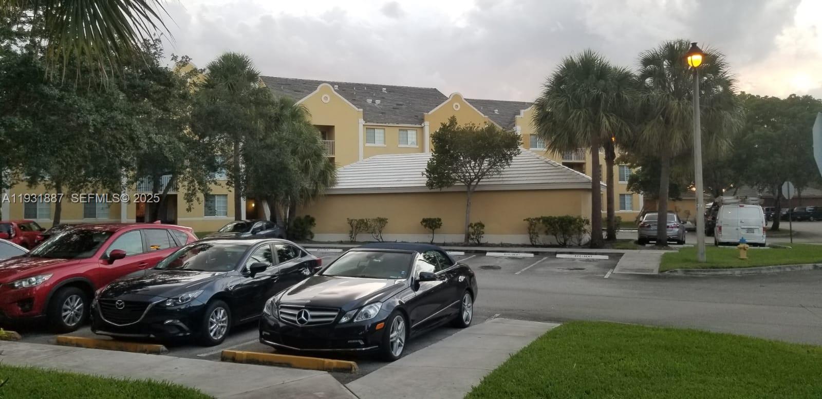 11145 Southwest 6th Street, Unit 104 Pembroke Pines, FL 33025 - Photo 25 of 37 a couple of cars parked in front of a house