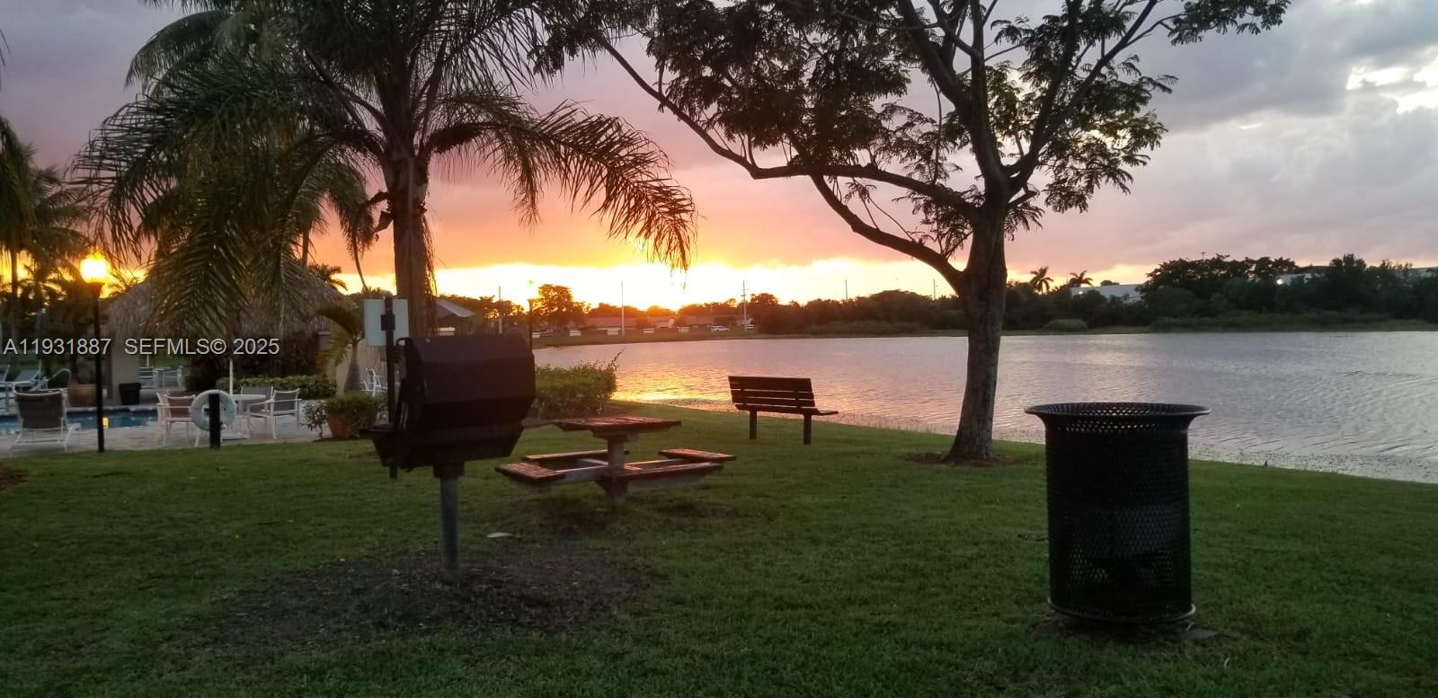 11145 Southwest 6th Street, Unit 104 Pembroke Pines, FL 33025 - Photo 32 of 37 a view of a lake with a table and chairs