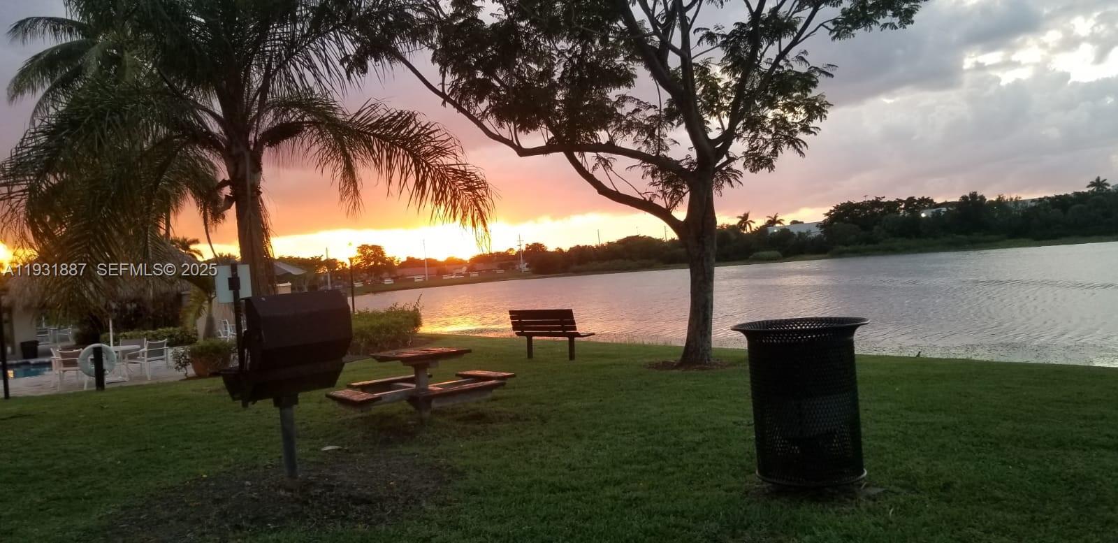 11145 Southwest 6th Street, Unit 104 Pembroke Pines, FL 33025 - Photo 34 of 37 a view of a lake with a garden and trees