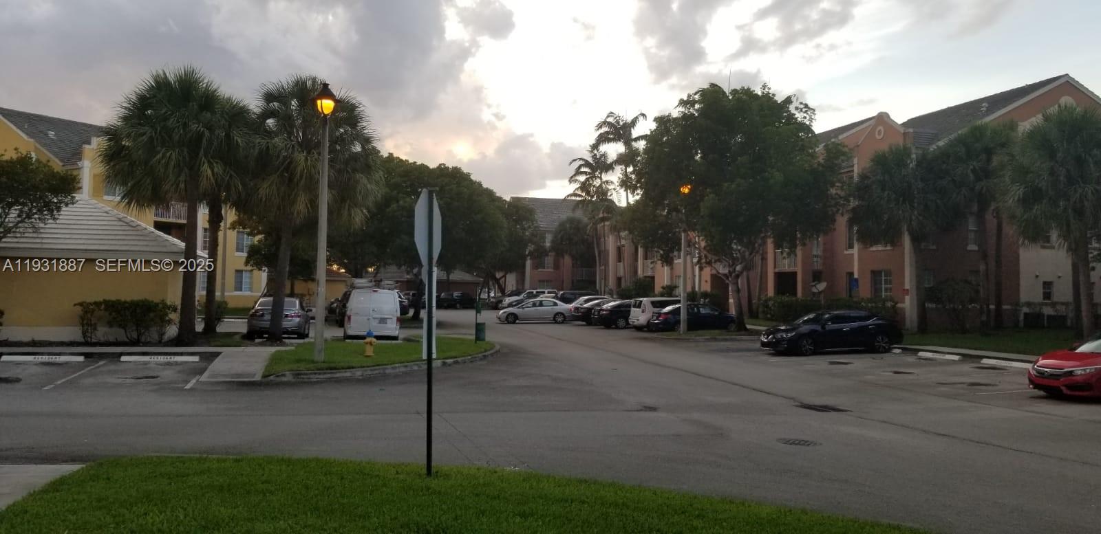 11145 Southwest 6th Street, Unit 104 Pembroke Pines, FL 33025 - Photo 35 of 37 a view of a parked cars in front of a house
