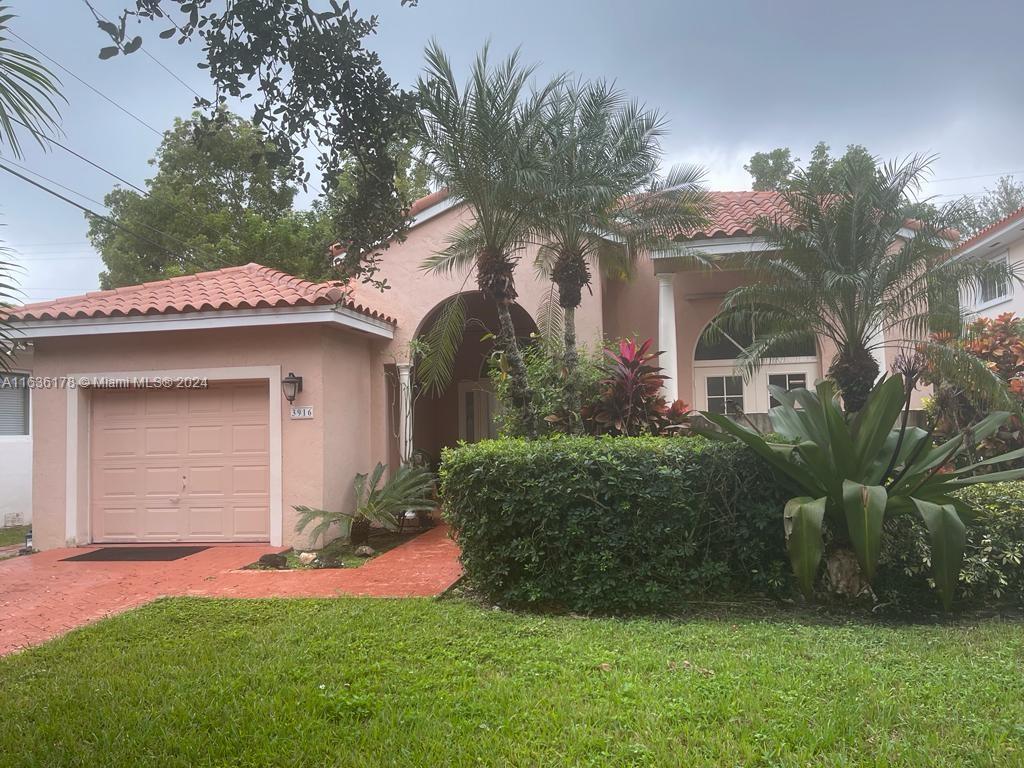 3916 Anderson Road Coral Gables, FL 33134 - Photo 1 of 1 a front view of a house with a garden and yard