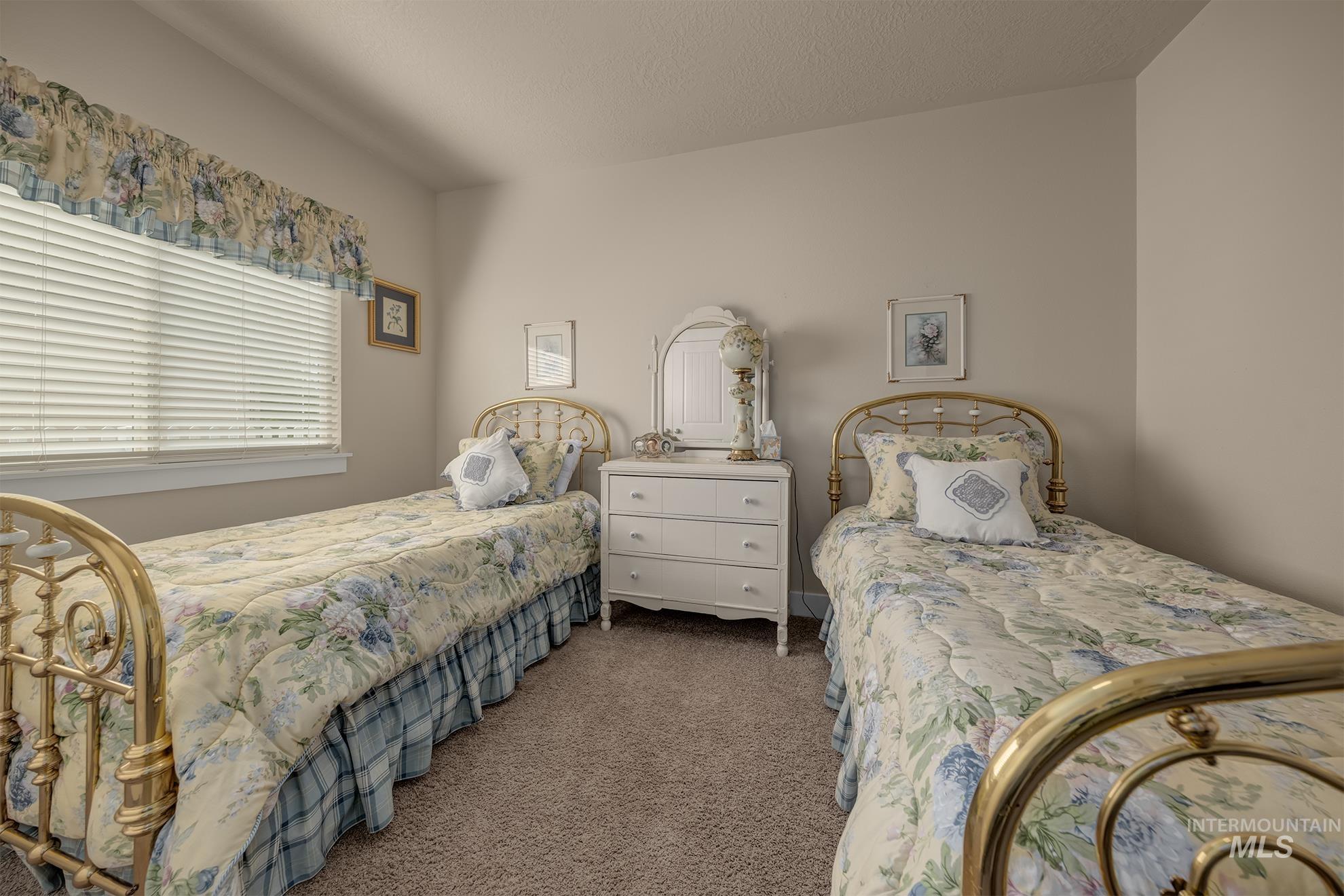 420 West Indianhead Road Weiser, ID 83672 - Photo 20 of 40 Bright room featuring a window with blinds, neutral wall color, and carpeted flooring
