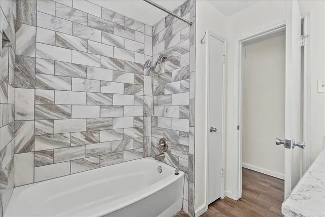 a bathroom with a bathtub and shower