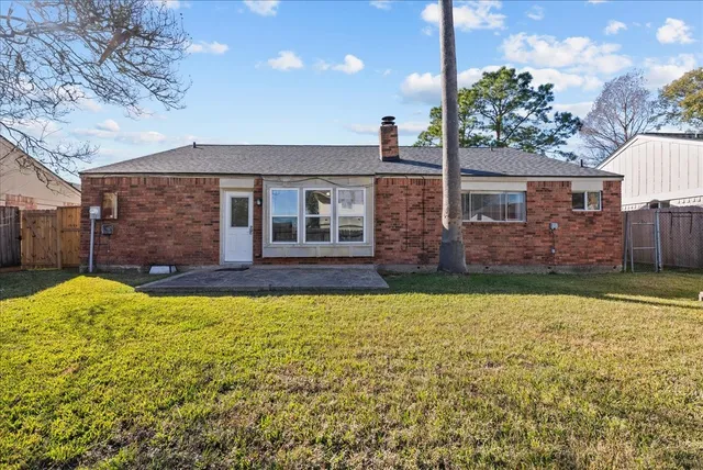 a view of house with a yard
