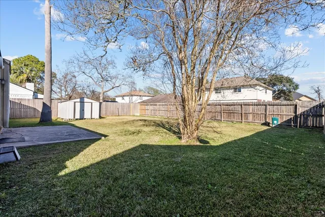 a view of yard with swimming pool and seating
