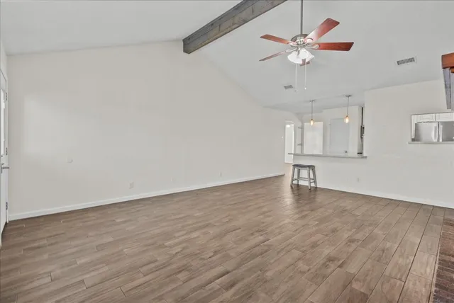wooden floor in an empty room with a window