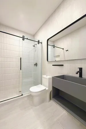 a bathroom with a sink toilet and shower