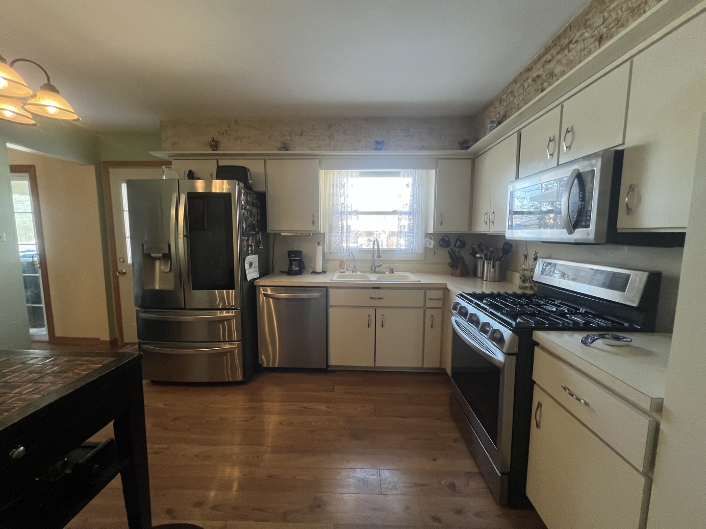 620 Willow Street Frankfort, IL 60423 - Photo 11 of 32 a kitchen with refrigerator a microwave a sink and cabinets