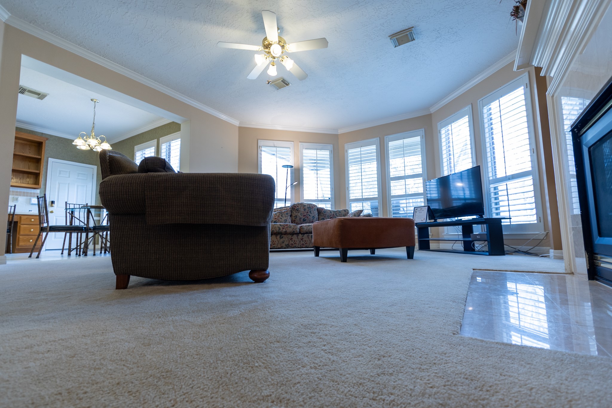5718 Oakmoss Trail Spring, TX 77379 - Photo 13 of 50 This inviting living area features crown molding and abundant natural light from expansive windows.